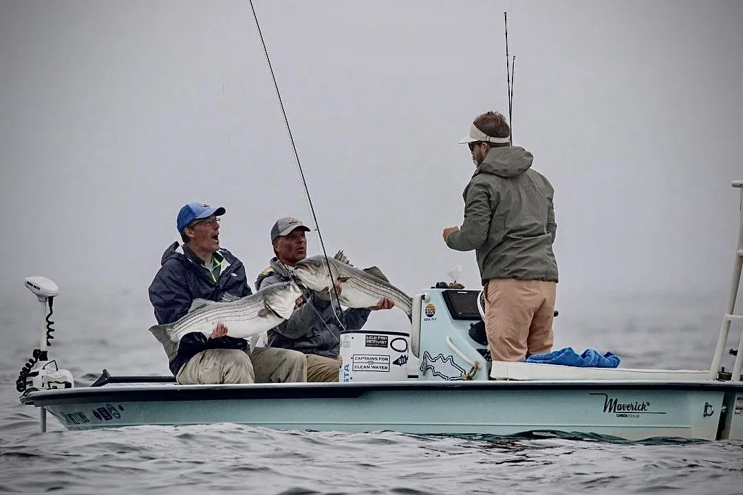 Kyle guiding clients to striped bass in Maine