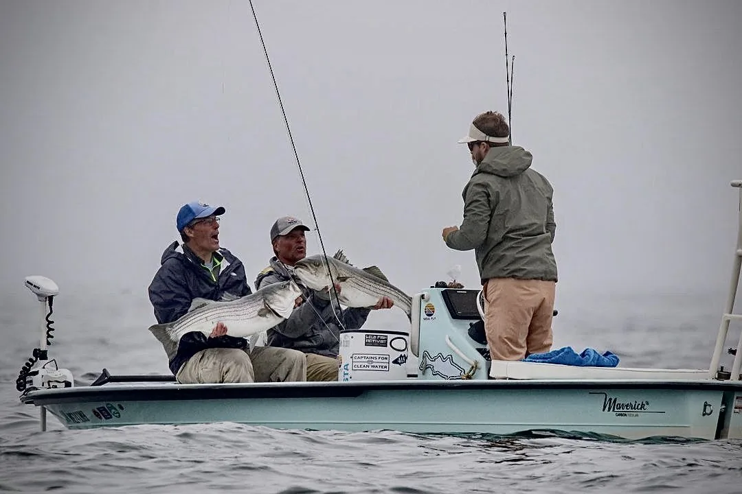 Kyle guiding clients to striped bass in Maine