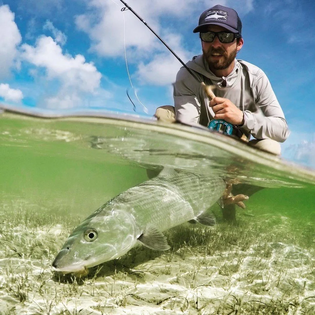 Kyle with a bonefish, shot over-under on a Bahamas flat